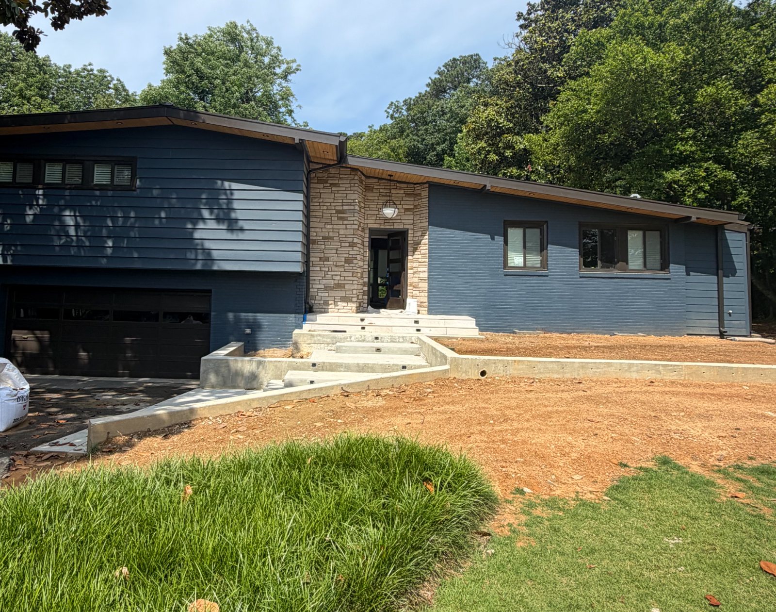 Repainted mid-century home exterior in navy with stone entry, Birmingham AL
