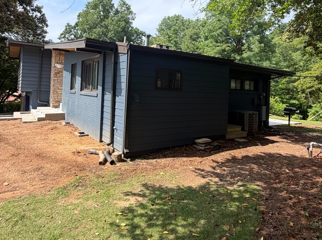 Side elevation of a home repainted navy and charcoal