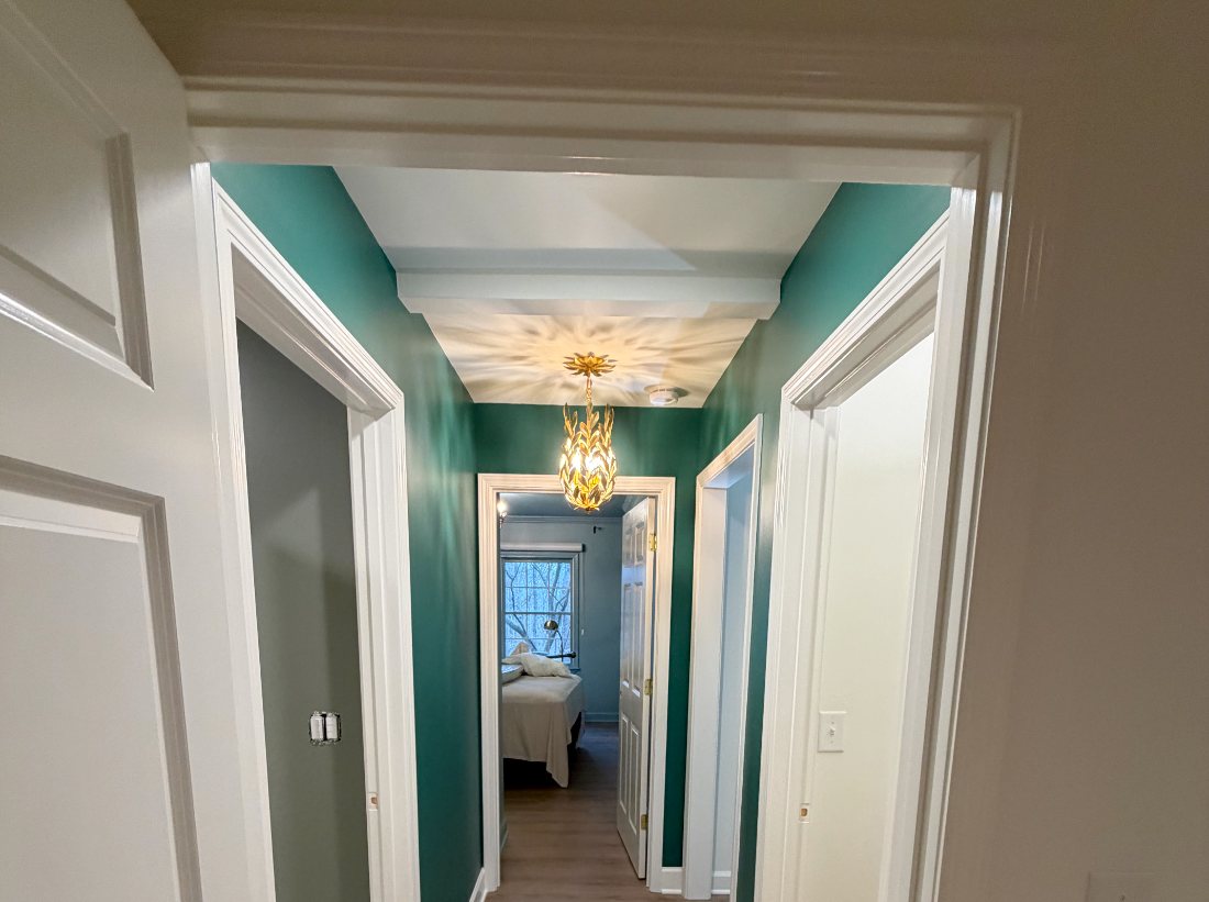 Interior hallway painted deep green with crisp white trim